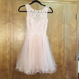 Knee length light pink dress.
